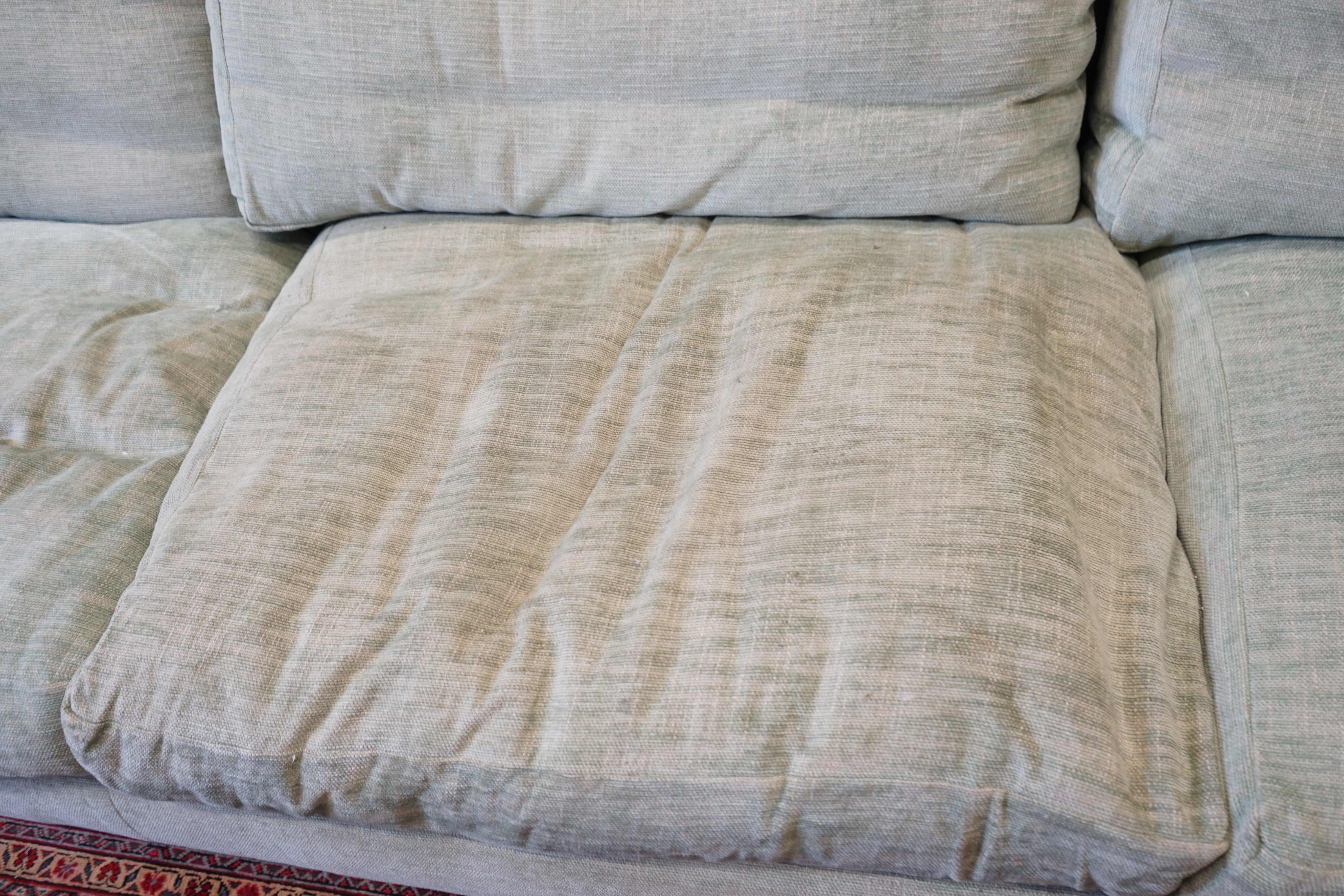 A large Howard style three seater settee upholstered in pale green fabric, length 300cm, depth 120cm, height 92cm